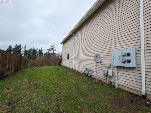 view of property exterior featuring a yard and fence