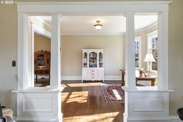 interior space with crown molding, wood-type flooring, and ornate columns