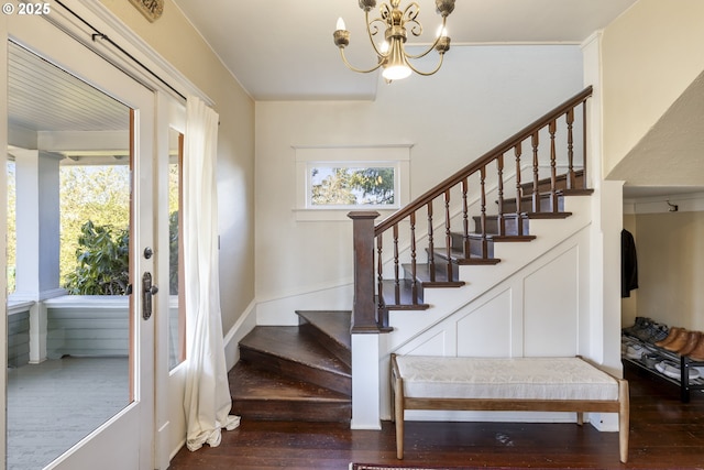 entrance foyer with plenty of natural light, dark hardwood / wood-style flooring, and a notable chandelier