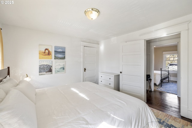 bedroom with dark hardwood / wood-style flooring