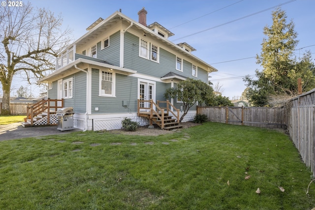 rear view of house with french doors and a yard