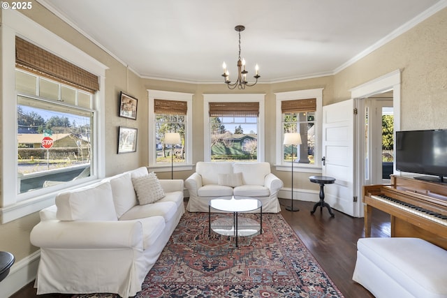 living room featuring an inviting chandelier, crown molding, and dark hardwood / wood-style floors