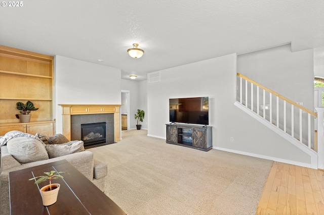 1845 S 15th Ct, Ridgefield, WA 98642 - living room with a tile fireplace, stairs, and baseboards