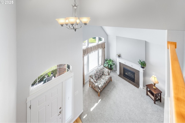 1845 S 15th Ct, Ridgefield, WA 98642 - carpeted living room featuring a chandelier, vaulted ceiling, and a tile fireplace
