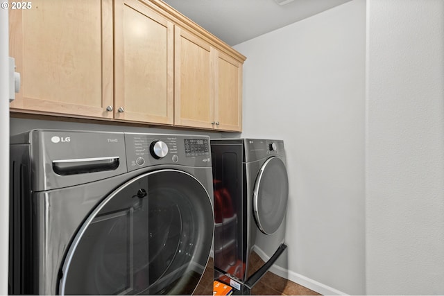 1845 S 15th Ct, Ridgefield, WA 98642 - washroom with washing machine and clothes dryer, cabinet space, baseboards, and tile patterned flooring