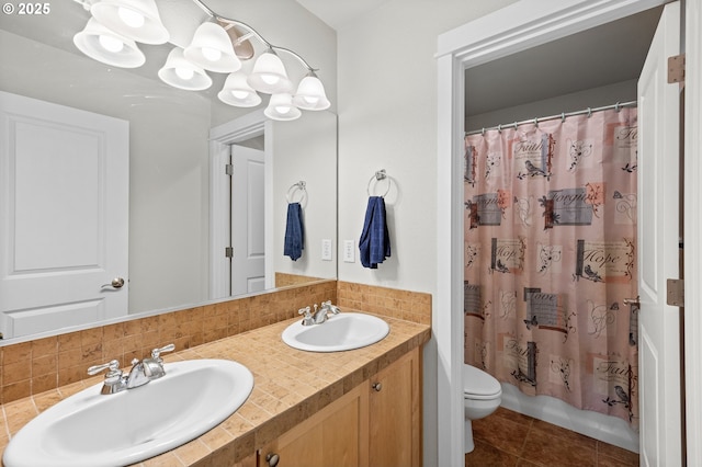 1845 S 15th Ct, Ridgefield, WA 98642 - bathroom with double vanity, toilet, tasteful backsplash, tile patterned flooring, and shower / bath combo