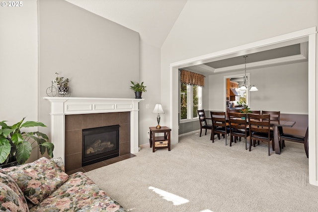 1845 S 15th Ct, Ridgefield, WA 98642 - living area with carpet flooring, vaulted ceiling, a tile fireplace, and baseboards