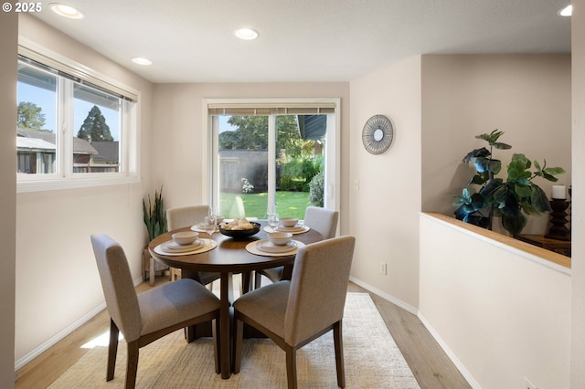 dining area featuring light wood-type flooring, recessed lighting, and baseboards