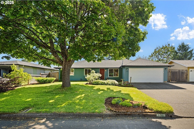 ranch-style house with driveway and an attached garage