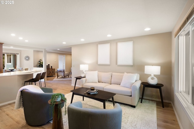 living room with light wood-style flooring, baseboards, and recessed lighting