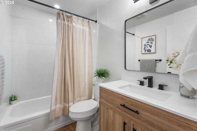 full bathroom with vanity, shower / bath combo, a textured ceiling, and toilet