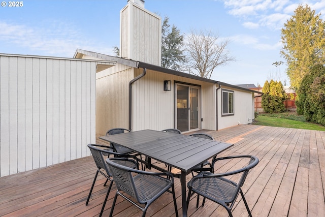 wooden deck with outdoor dining space and fence