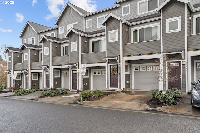 multi unit property with concrete driveway and an attached garage