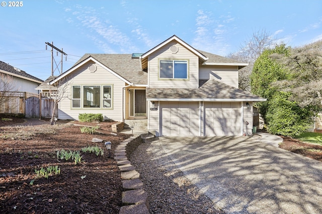 view of front of home with driveway, a garage, fence, and roof with shingles