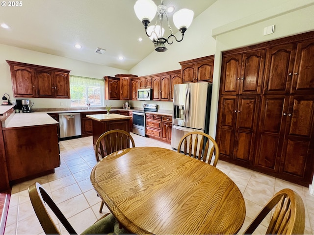 2295 Chi Chi Ln, Sutherlin, OR 97479 - kitchen featuring appliances with stainless steel finishes, lofted ceiling, a center island, recessed lighting, and light tile patterned floors