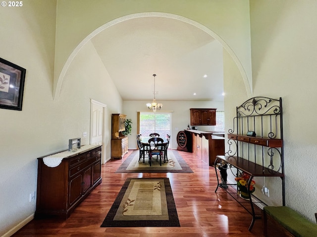 2295 Chi Chi Ln, Sutherlin, OR 97479 - corridor featuring dark wood-style floors, a chandelier, arched walkways, baseboards, and high vaulted ceiling