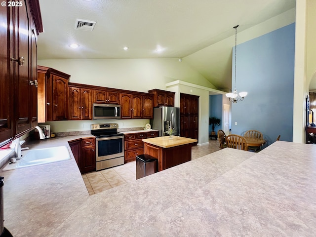 2295 Chi Chi Ln, Sutherlin, OR 97479 - kitchen featuring appliances with stainless steel finishes, a sink, high vaulted ceiling, a chandelier, and light countertops