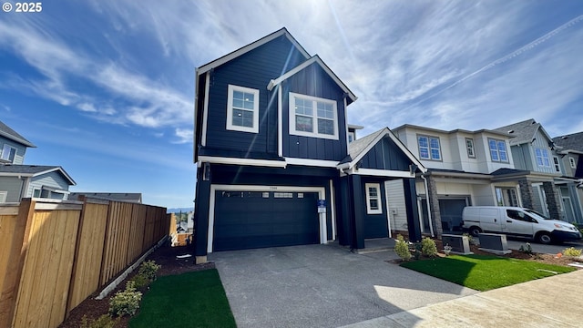 17880 SW Alvord Ln, Beaverton, OR 97007 - view of front of property with concrete driveway, a residential view, board and batten siding, an attached garage, and fence
