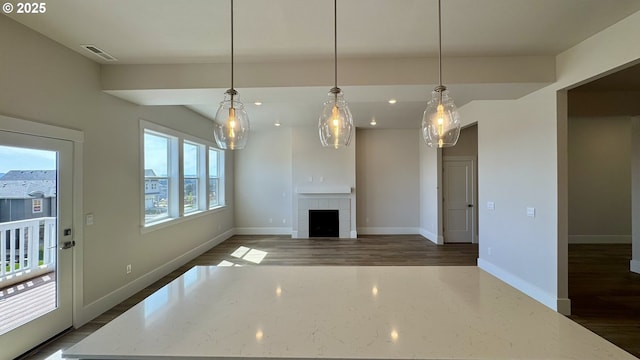 17880 SW Alvord Ln, Beaverton, OR 97007 - unfurnished living room with dark wood-style flooring, a tiled fireplace, baseboards, visible vents, and recessed lighting