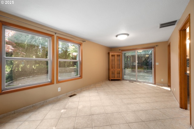 empty room with visible vents and light tile patterned floors