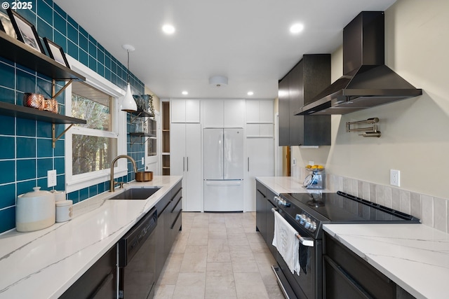 kitchen with pendant lighting, ventilation hood, sink, light stone counters, and black appliances