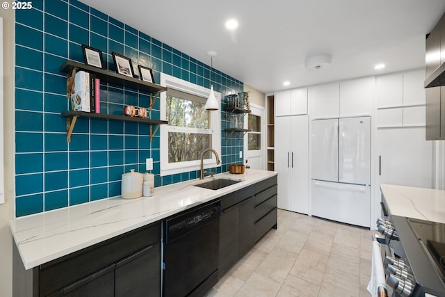 kitchen with sink, dishwasher, white cabinetry, white refrigerator, and light stone countertops