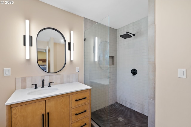 bathroom with vanity, backsplash, and walk in shower