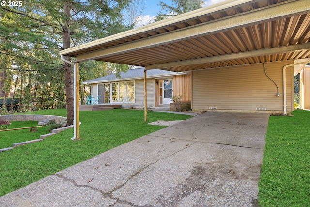 exterior space with a carport and a yard