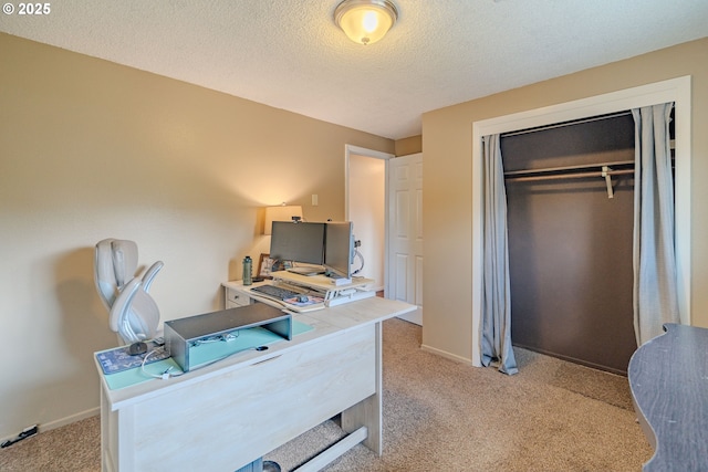 home office with a textured ceiling, light carpet, and baseboards