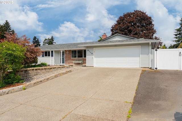 ranch-style house with driveway, a chimney, a garage, brick siding, and fence