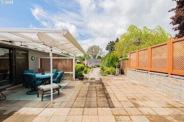 view of patio / terrace with a fenced backyard, a pergola, and outdoor dining space