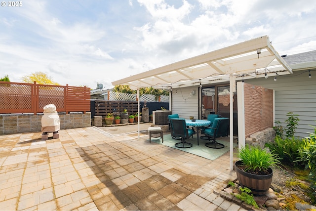 view of patio featuring a pergola, outdoor dining area, and a fenced backyard