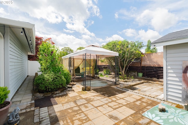 view of patio / terrace featuring a fenced backyard and a gazebo