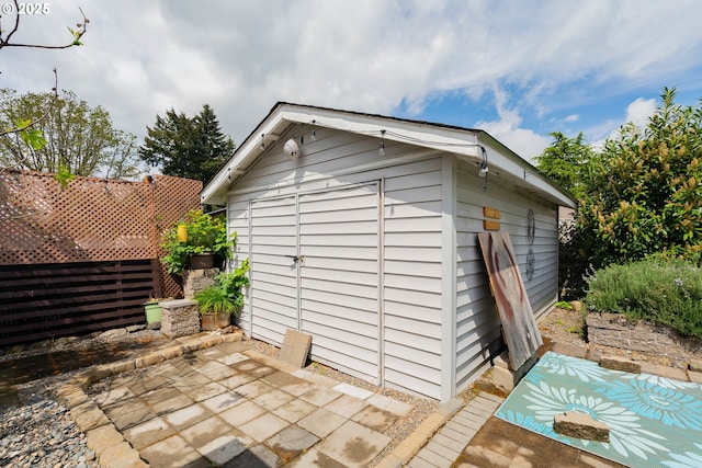 view of shed featuring fence
