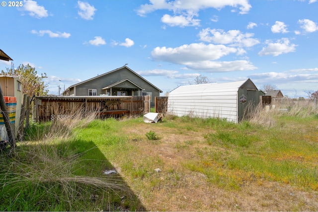 rear view of house featuring an outbuilding and a shed