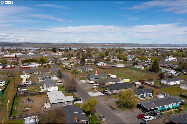 bird's eye view featuring a water view and a residential view