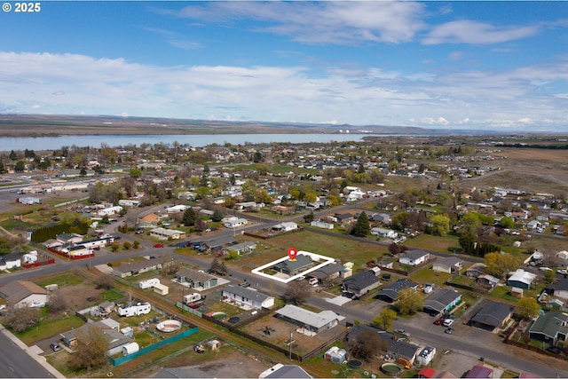 birds eye view of property featuring a water view and a residential view