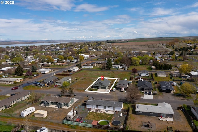 birds eye view of property with a water view and a residential view