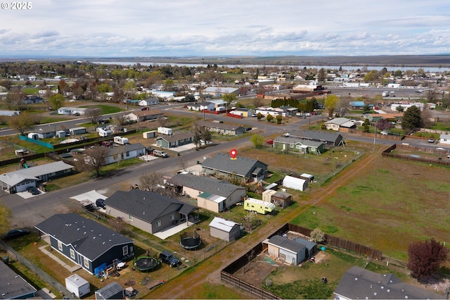 birds eye view of property with a water view and a residential view