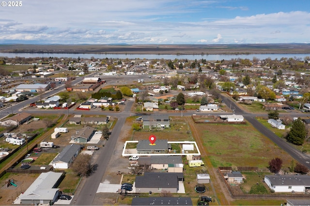 birds eye view of property with a water view and a residential view