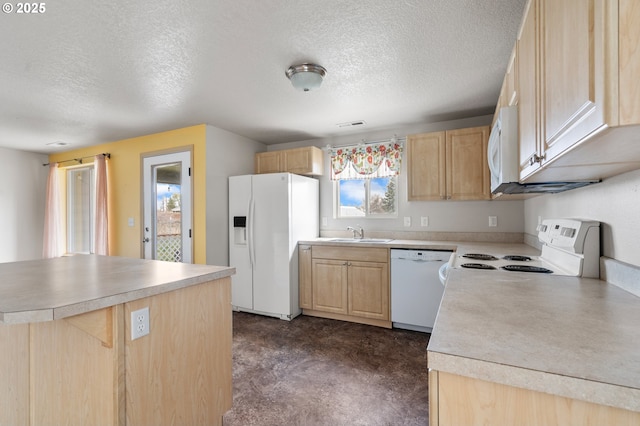 kitchen featuring a sink, light countertops, white appliances, light brown cabinetry, and a textured ceiling