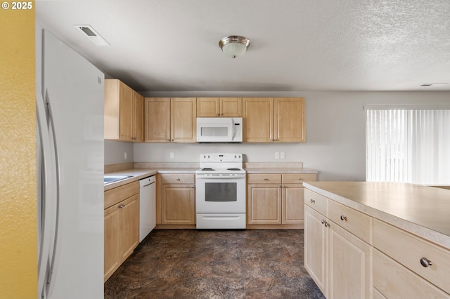 kitchen featuring visible vents, light countertops, white appliances, light brown cabinetry, and a textured ceiling