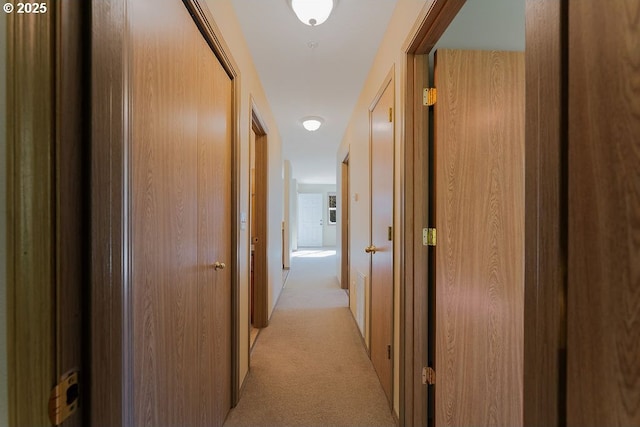hall with light colored carpet