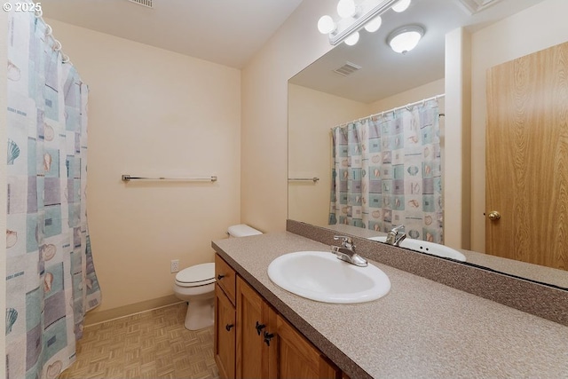 bathroom featuring toilet, vanity, and a shower with curtain