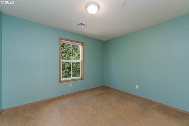 carpeted empty room with baseboards and a pendent fire sprinkler