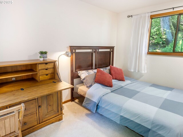 bedroom featuring light colored carpet