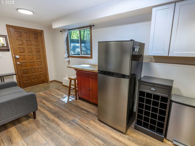 kitchen featuring freestanding refrigerator and light wood finished floors