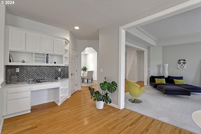 kitchen with light hardwood / wood-style flooring and white cabinets