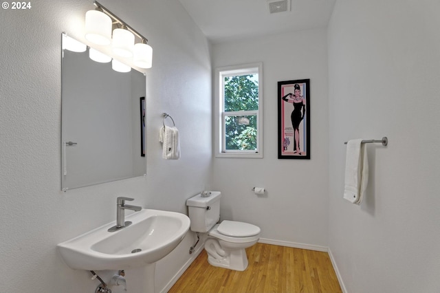 bathroom with sink, wood-type flooring, and toilet