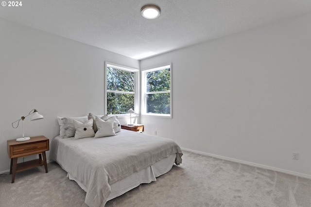 carpeted bedroom featuring a textured ceiling